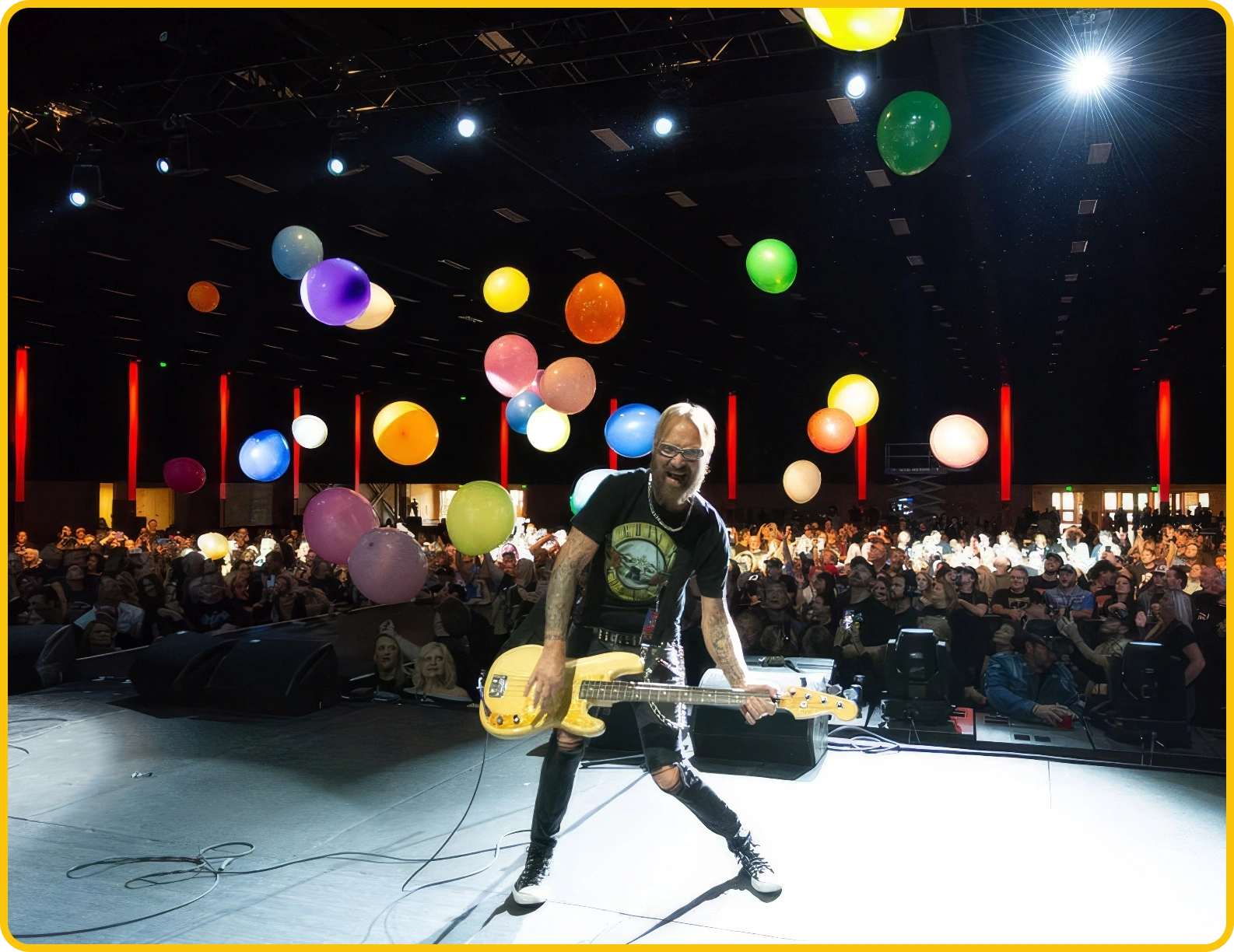 A man playing guitar on stage | The Mountain Music Festival